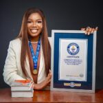 Theresa Emegwara Tesglam holding her Guinness World Record plaque in Lagos Nigeria.
