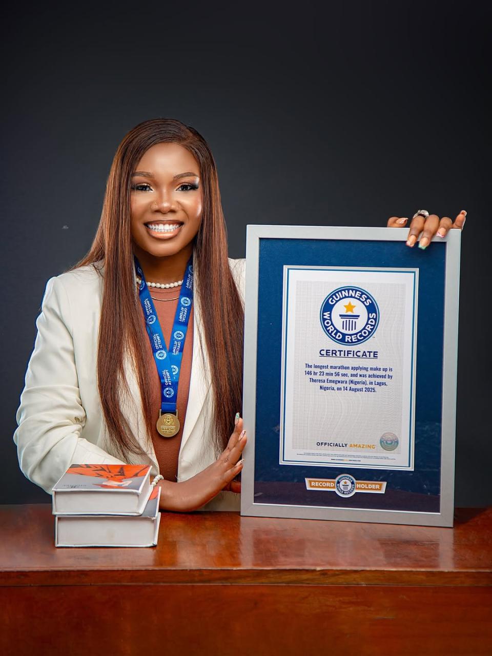 Theresa Emegwara Tesglam holding her Guinness World Record plaque in Lagos Nigeria.